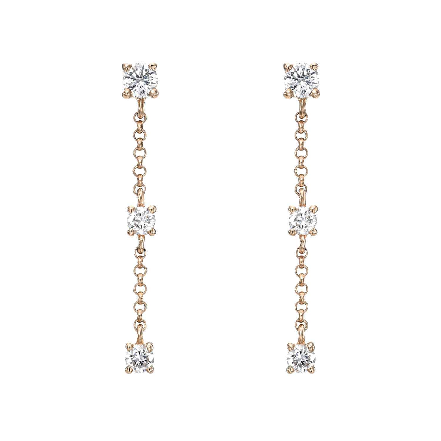 The 3 Drop Diamond Finley Earrings by Janet Heller Fine Jewelry are crafted in 14KT gold. The dangling earrings feature three evenly spaced round diamonds connected by a delicate chain. The earrings can be worn alone or layered along the ear with other earrings.