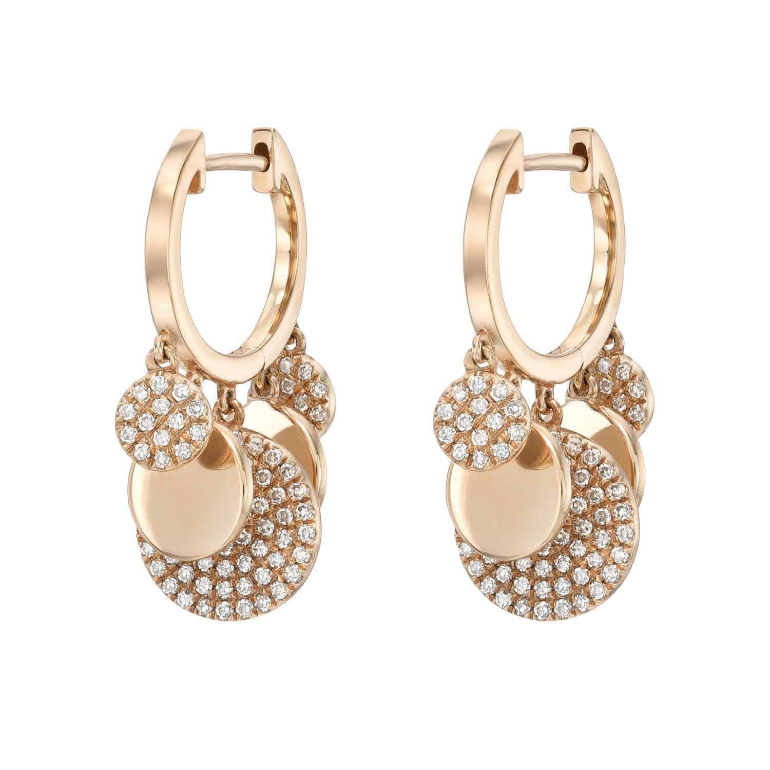 The Alternating Diamond Disc Huggies by Janet Heller are elegant gold hoop earrings adorned with multiple dangling circular charms—some glittering with pavé-set clear crystals and others boasting a polished gold finish. This sophisticated piece of fine jewelry adds a sparkling touch to any ensemble.