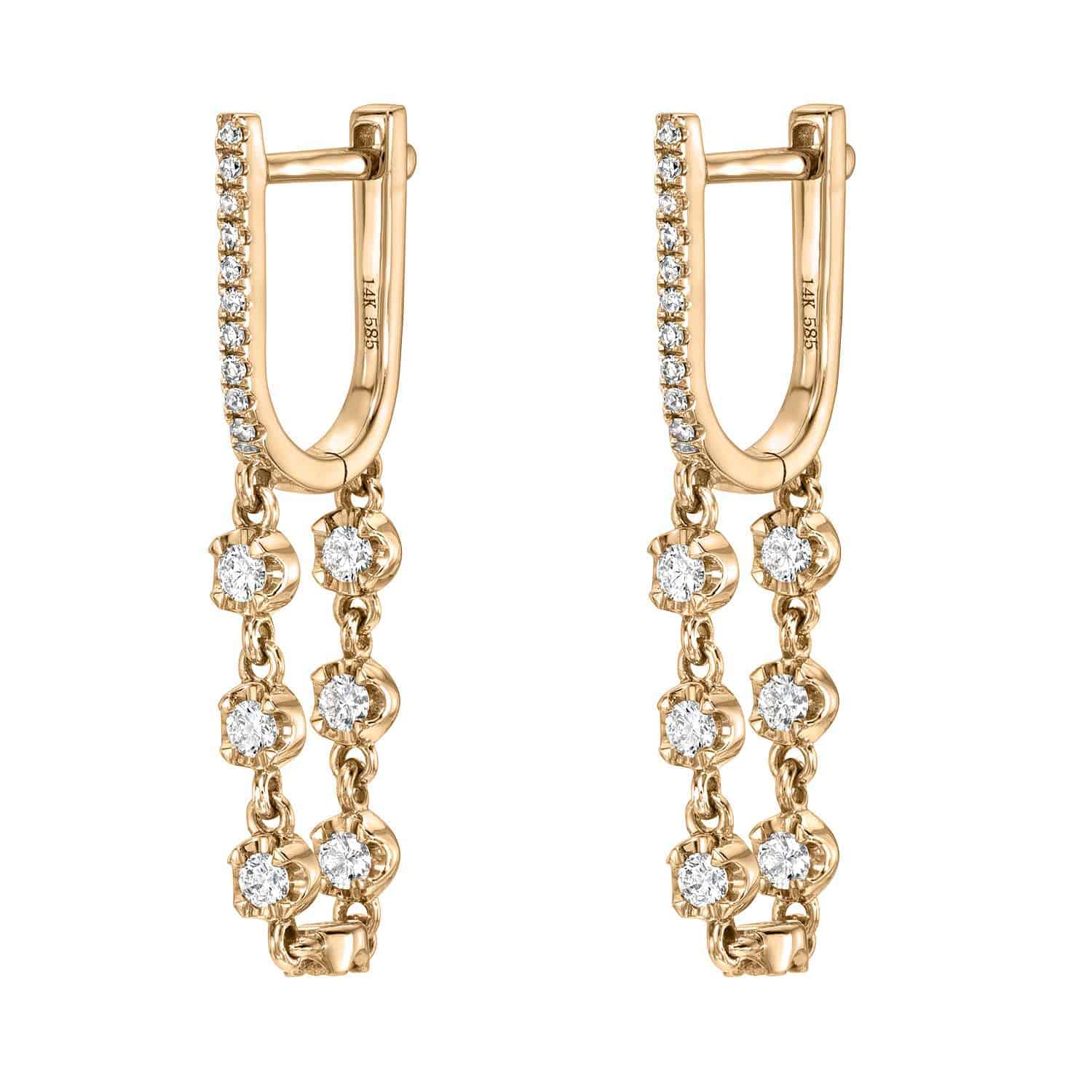 Introducing the Diamond Loop Huggies from Janet Heller Fine Jewelry: these exquisite gold earrings feature a row of petite diamonds along the hoop, accented by two delicate dangling gold chains, each adorned with sparkling round diamonds. Experience the timeless elegance and masterful craftsmanship of fine jewelry perfected.