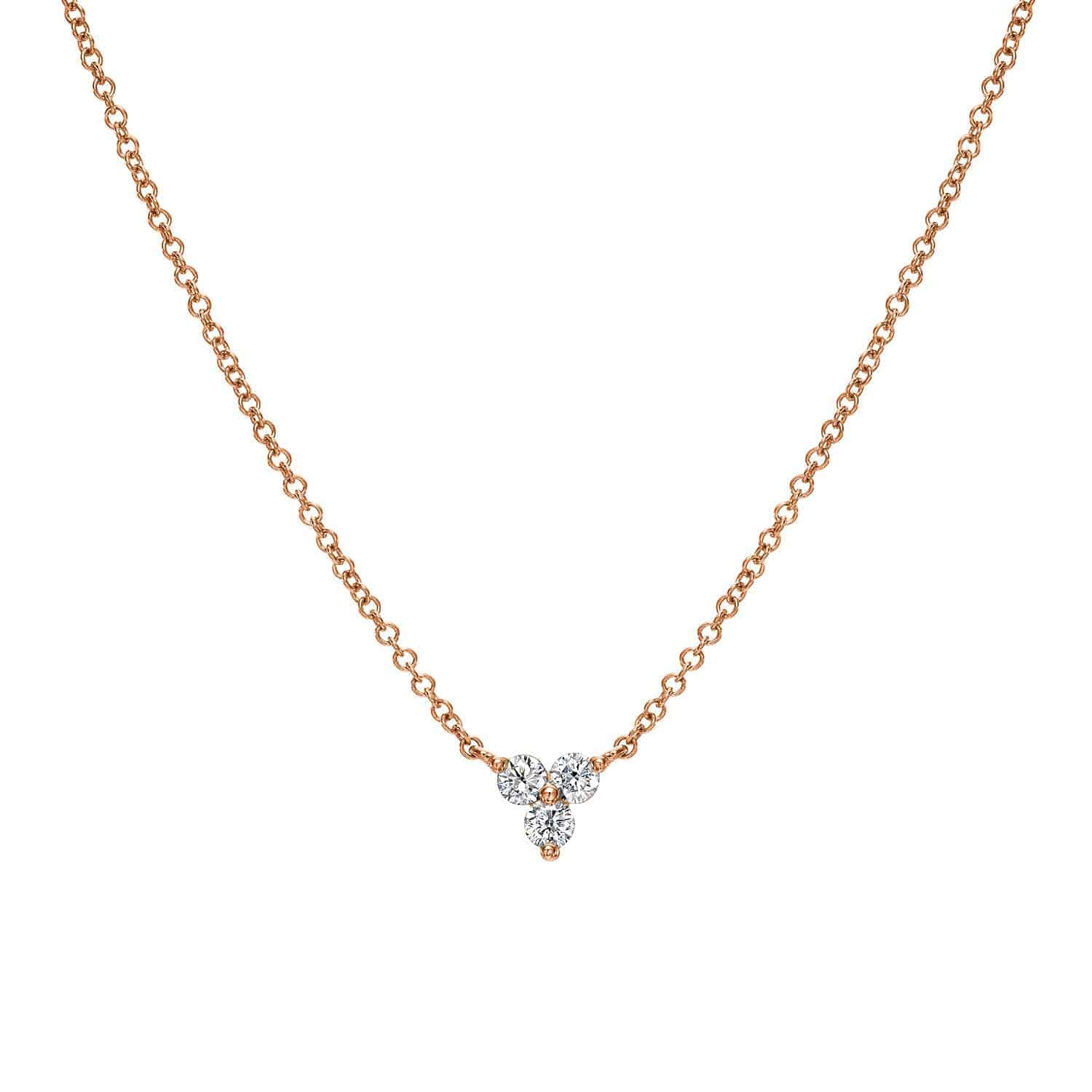 The Diamond Maisy Necklace is a fine jewelry piece featuring a delicate gold chain and a pendant with three small diamonds in a triangular formation, creating an elegant and simple design that invites inquiries and customizations.