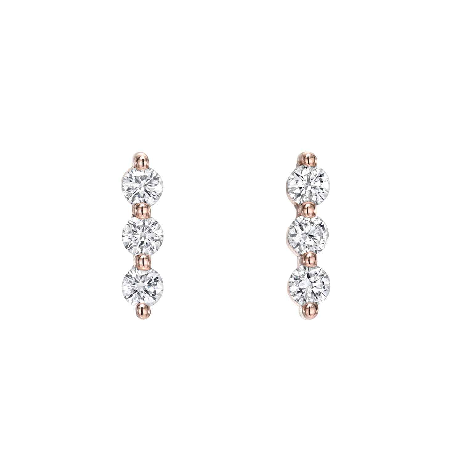 Explore the elegance of Diamond Trio Bar Studs by Janet Heller Fine Jewelry, featuring round diamonds set vertically in rose gold prongs. Displayed on a white background, these exquisite earrings can be customized to suit your unique style.