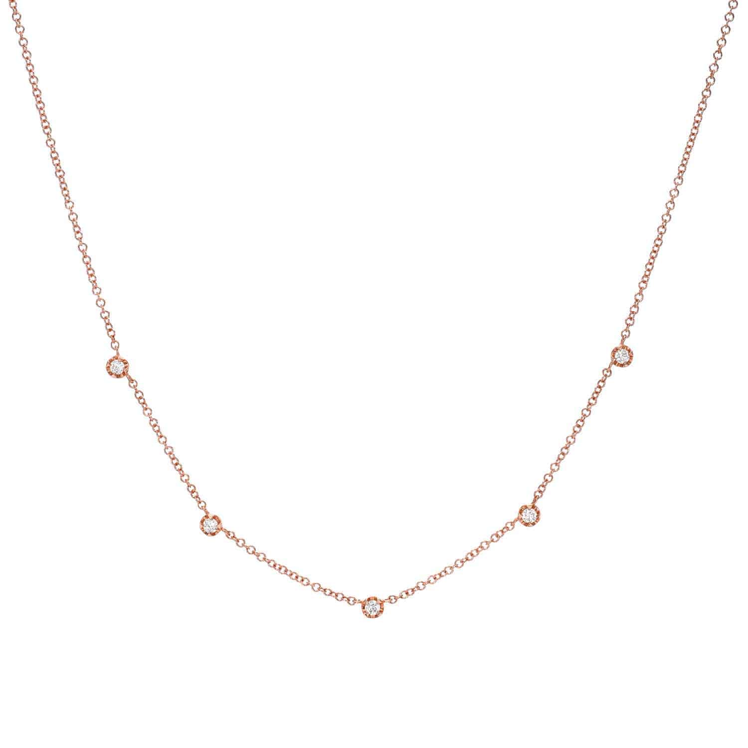 The Diamond Vienna Necklace by Janet Heller Fine Jewelry is crafted in 14KT gold and features a delicate gold chain adorned with five diamonds. The necklace can be worn on its own or layered with other chains.