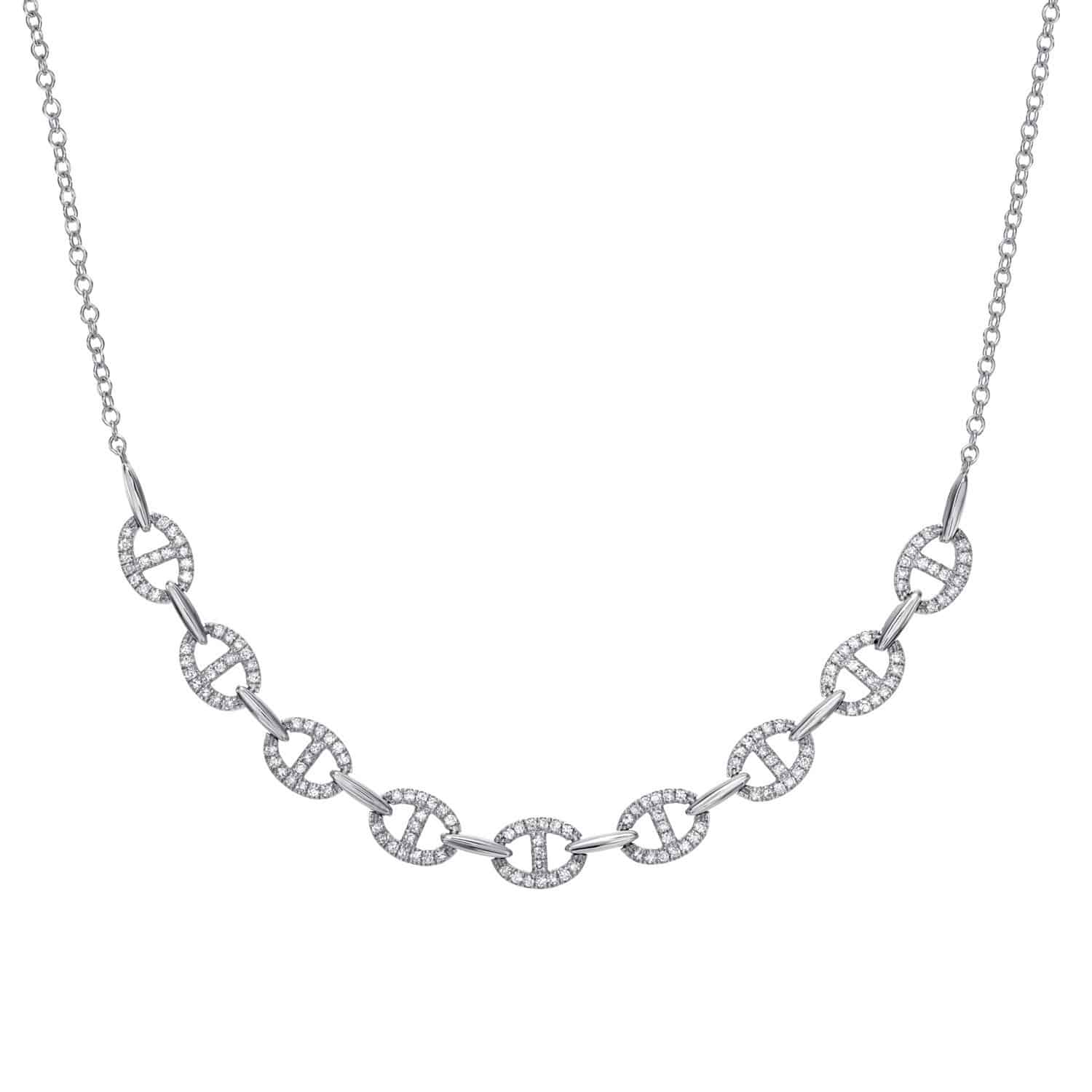 The Full Diamond Kaia Necklace is a silver piece with a chain-link design, featuring nine circular links adorned with sparkling stones and connected by oval silver links. It boasts an evenly spaced, symmetrical design that adds a classic and elegant touch to the exquisite jewelry.