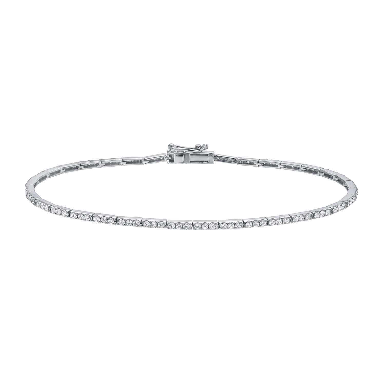 A delicate Micro Diamond Tennis Bracelet from Janet Heller Fine Jewelry, featuring a single row of small, sparkling diamonds set in a thin metal band with a secure clasp.