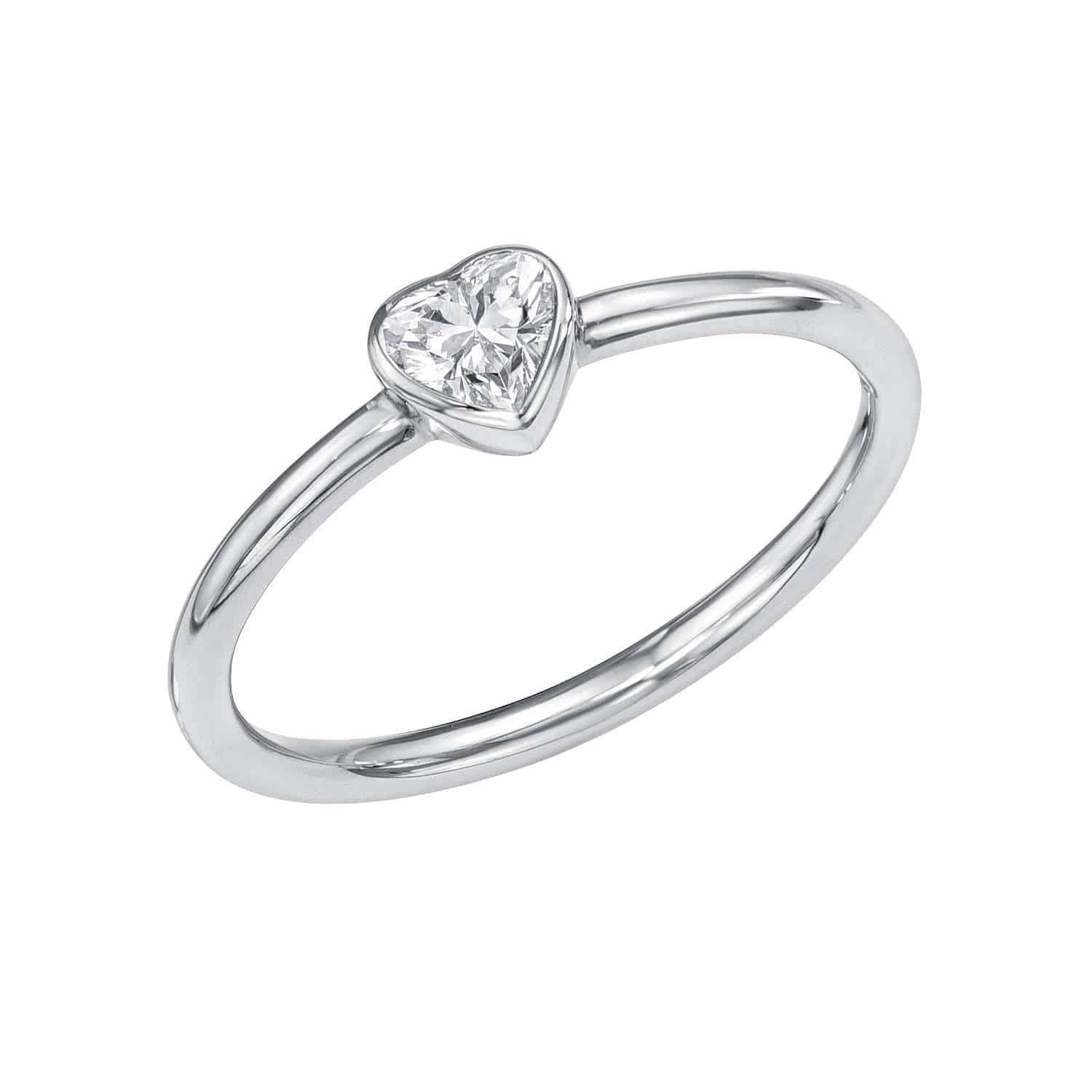 Introducing the Solitaire Diamond Heart Pinkie Ring by Janet Heller—a fine jewelry piece with a slender silver band and a sparkling heart-shaped diamond at its center, available for preorder.