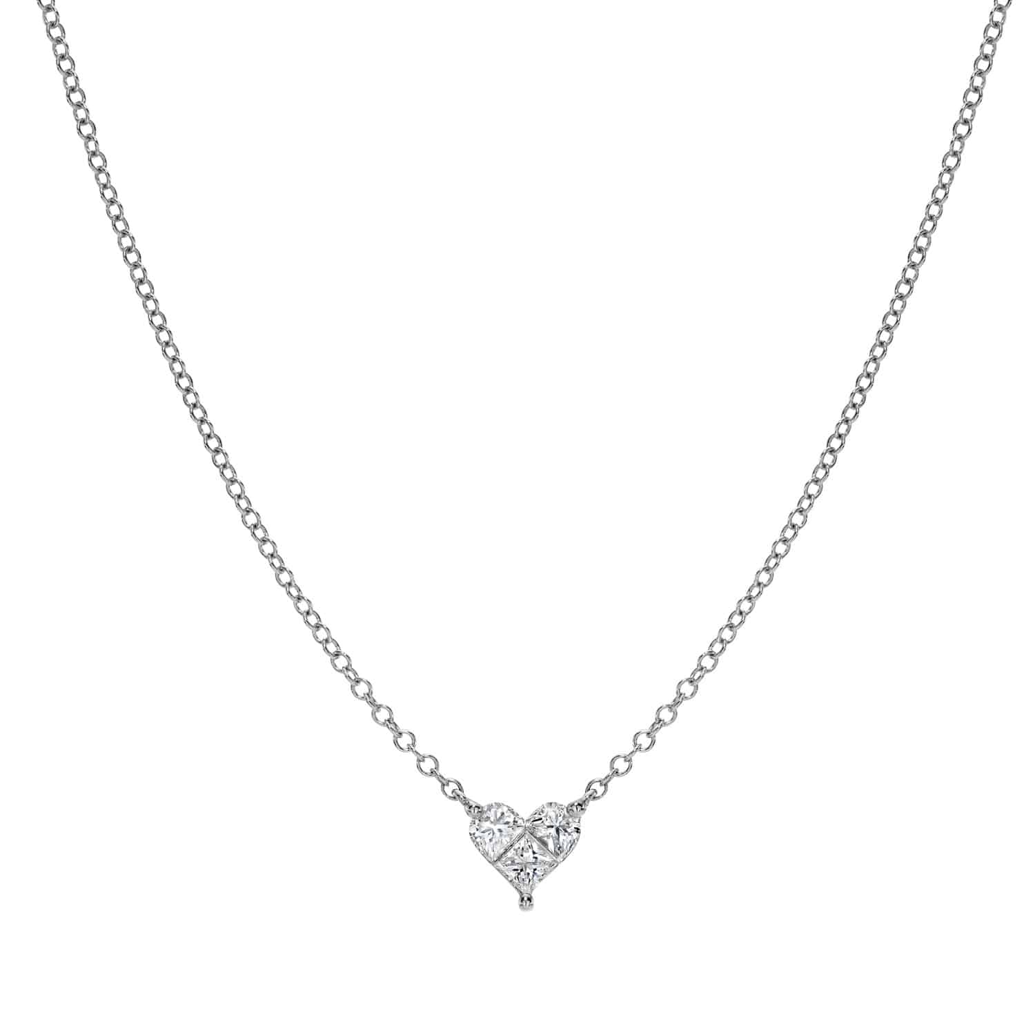 The Solitaire Heart Cut Diamond Necklace is a delicate silver chain with a sparkling heart-shaped pendant, featuring a clear gemstone at its center. This elegant piece offers simple sophistication and customizable options to enhance the charm of the heart pendant.