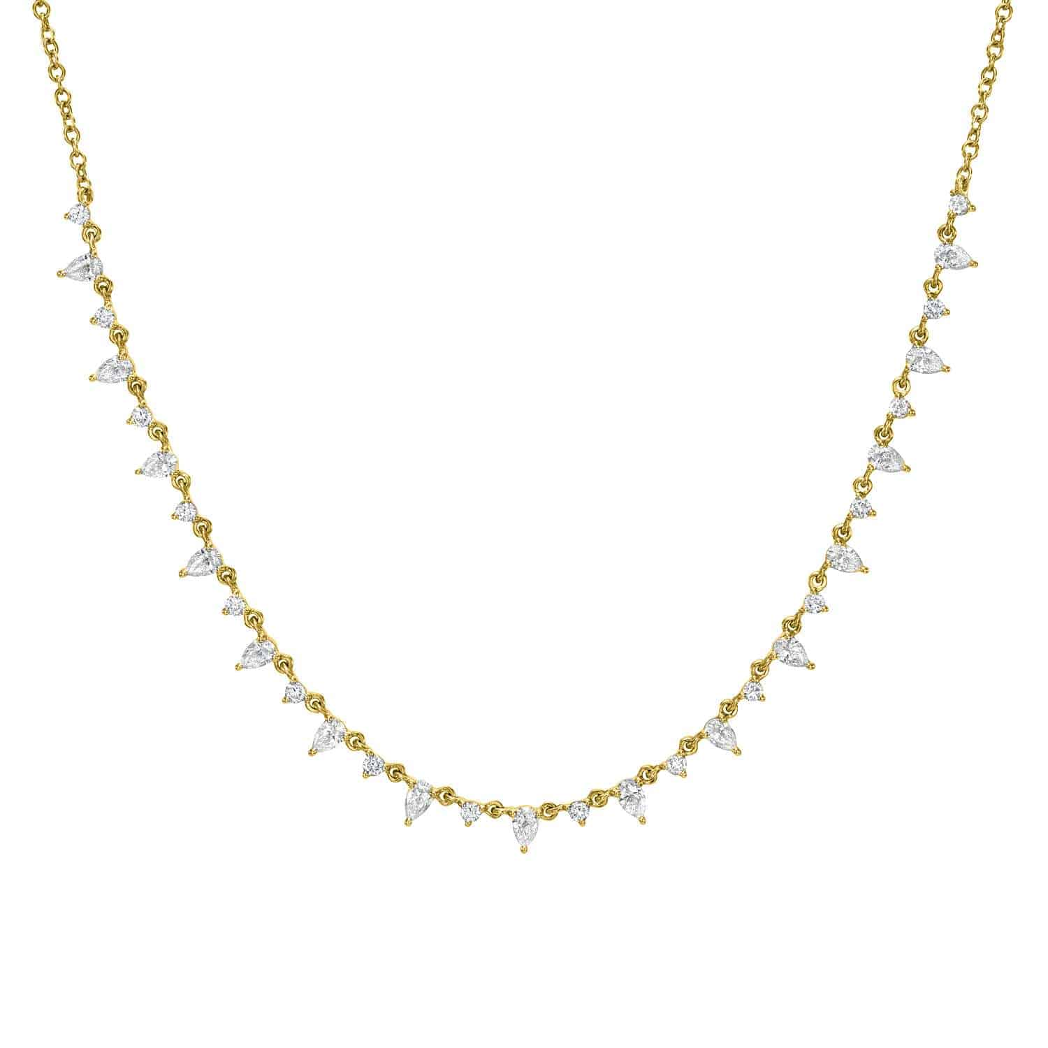The Pear Shaped Diamond Necklace is an exquisite gold piece adorned with sparkling pear-shaped diamonds along the chain. It adds sophistication to any ensemble and can be customized to match your unique style preferences.