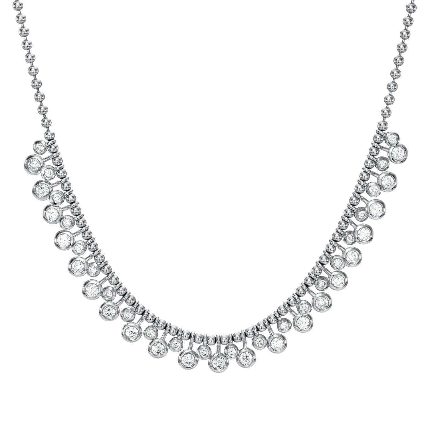 The Diamond Dangle Toilet Chain Necklace from Janet Heller Fine Jewelry is a silver piece with a beaded chain and circular, diamond-like stones that decrease in size towards the center, exuding elegance with its shiny detailing. For inquiries or customization, contact us.