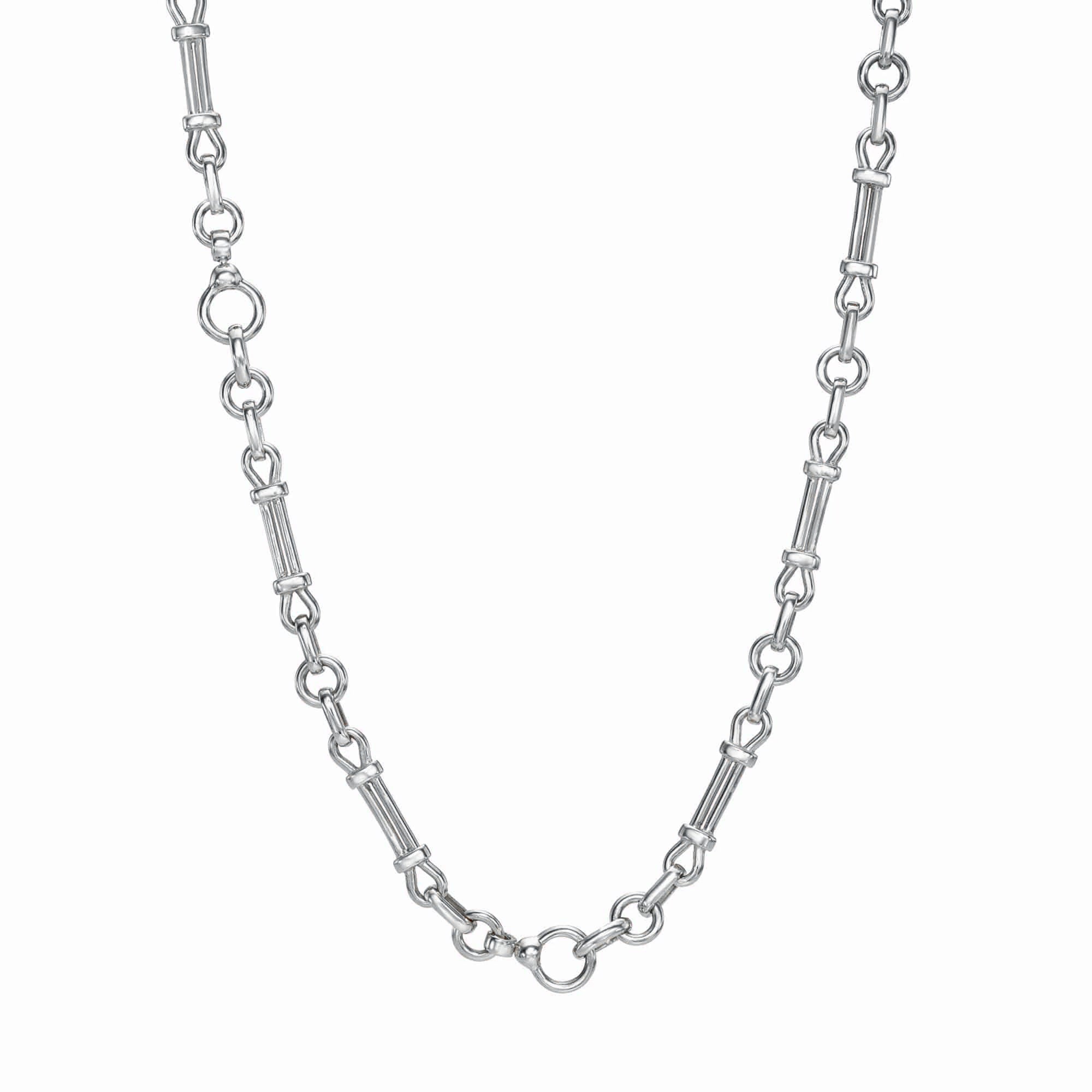 The Lisbon Chain by Janet Heller Fine Jewelry features alternating styles with groups of three small round rings and elongated links. Its simple, elegant design makes it suitable for various occasions, and against a plain white background, it exudes timeless charm.