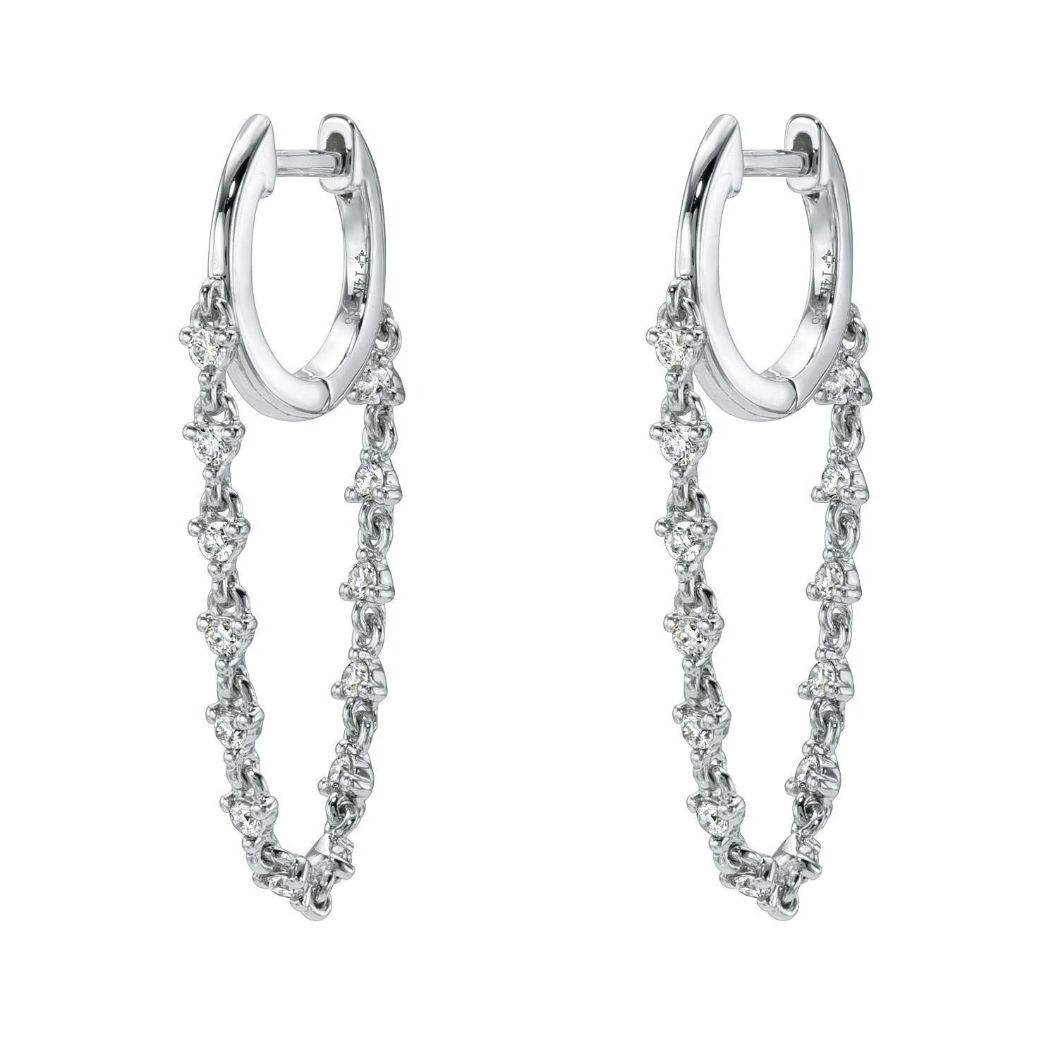 Introducing the 14KW Diamond Cascade Drop Huggies—an elegant pair of huggie earrings in 14k white gold, featuring delicate dangling chains adorned with sparkling round diamonds, beautifully showcased on a white background.
