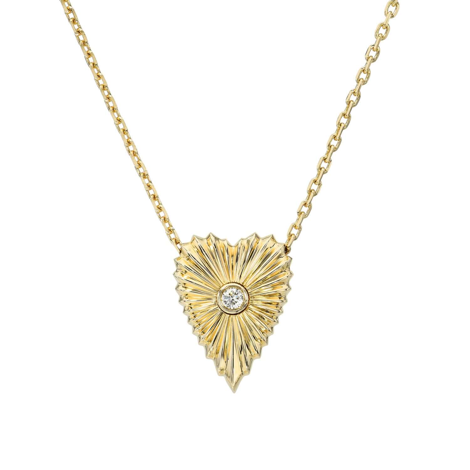The Diamond Elongated Heart Ribbed Necklace from Janet Heller Fine Jewelry is crafted in 14KT gold. This gold heart-shaped pendant showcases a sunburst design with a center diamond. The necklace can be worn alone or layered with other chains and necklaces.