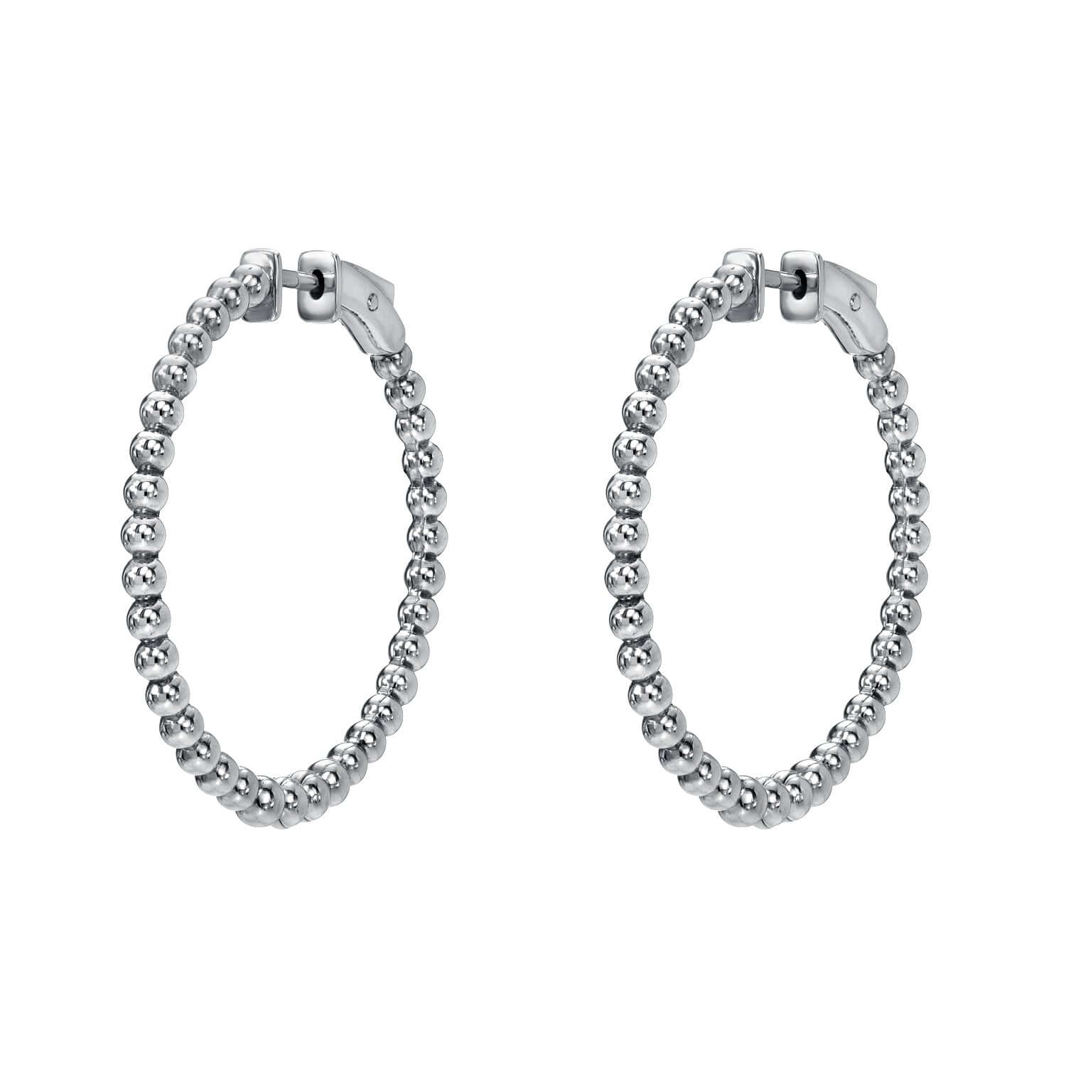 The Large Nora Hoops from Janet Heller Fine Jewelry are crafted in 14KT gold with small connected beads and clasp closures at the top. The earrings can be worn on their own or along the ear with other earrings.