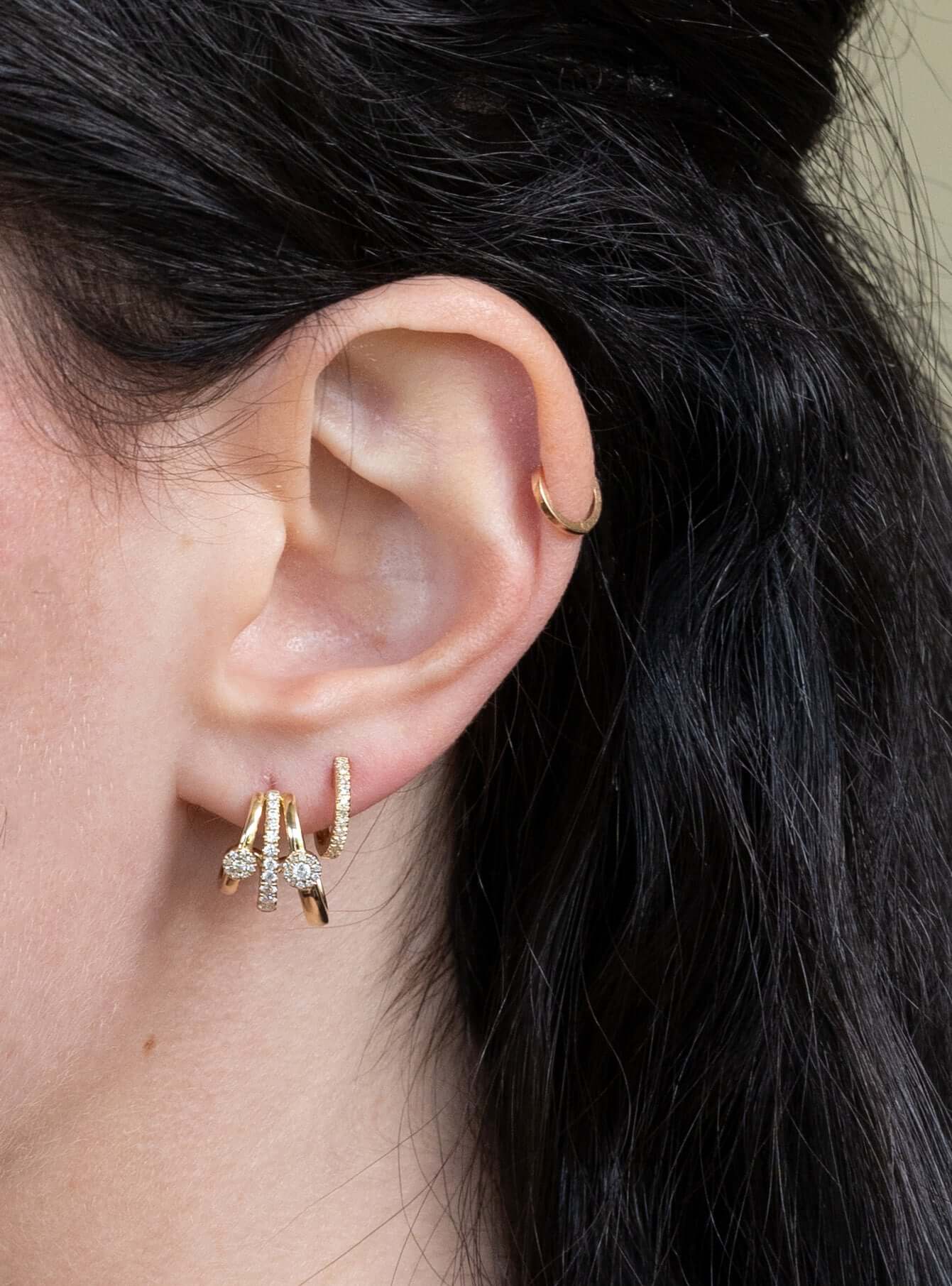 The Trio Diamond Wrap Earrings from Janet Heller Fine Jewelry are crafted in 14KT gold.  The earrings feature  three diamond-accented gold hoops. The earrings can be worn alone or layered along the ear with other earrings.