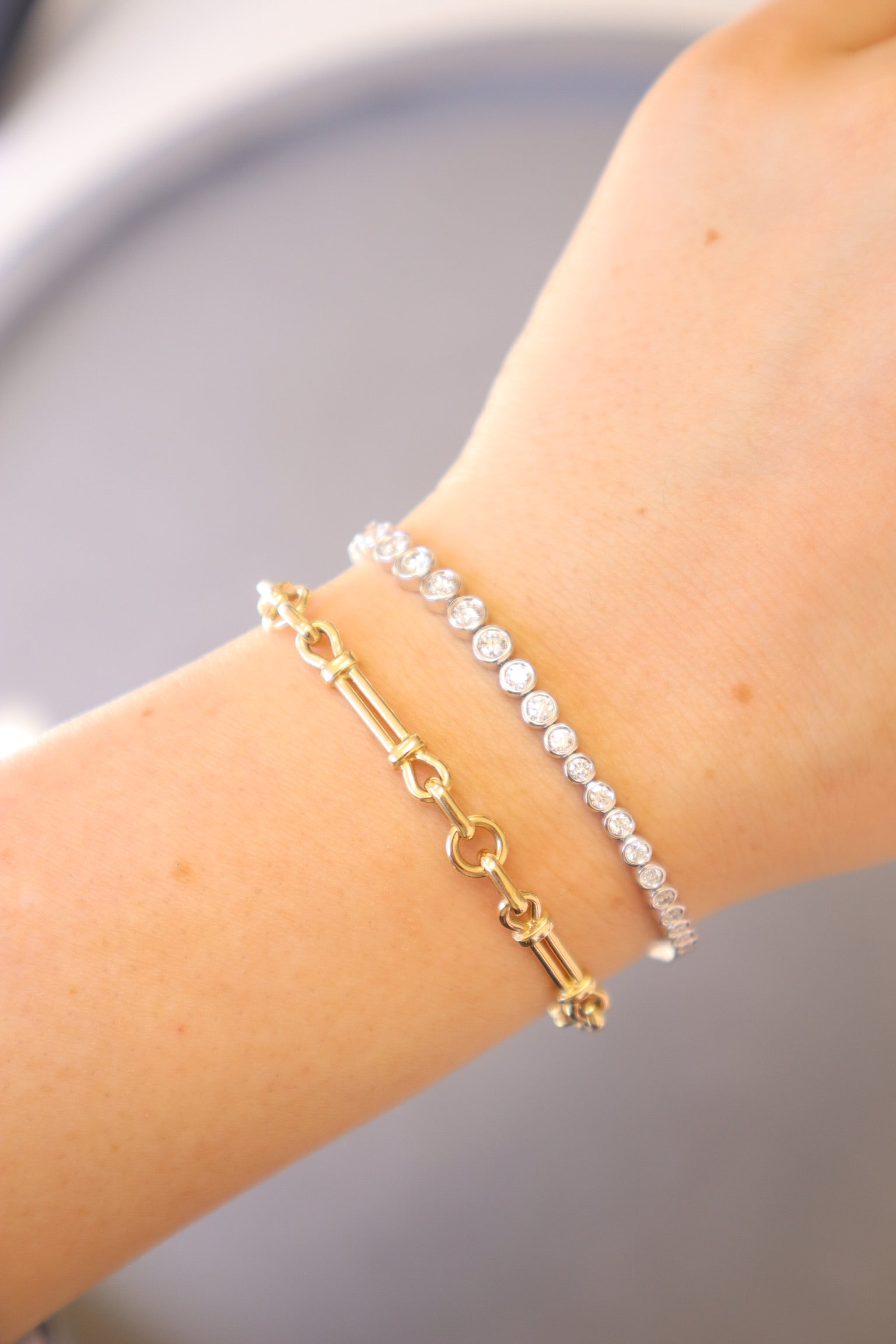The Lisbon Bracelet from Janet Heller Fine Jewelry is a gold link chain bracelet crafted in 14KT gold featuring bar and ring details with a diamond clasp.  The bracelet can be worn on its own or stacked with other bracelets.