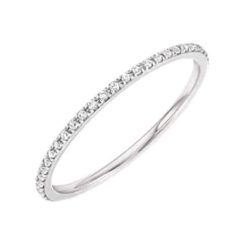 Displayed on a white background, the Micro Pavé Eternity Ring is a thin silver piece encrusted with small, sparkling diamonds around the band, available for preorder.