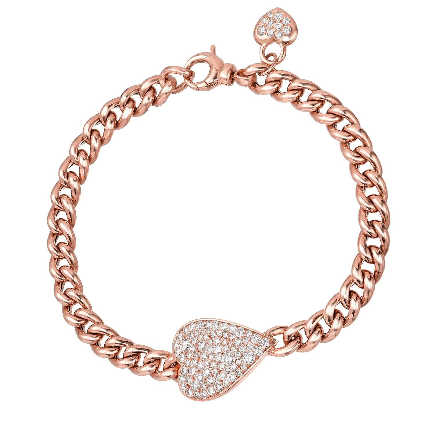 The Cuban Link Diamond Heart Bracelet from Janet Heller Fine Jewelry is crafted in 14KT gold. The chain features a diamond-encrusted heart-shaped pendant and a smaller diamond heart dangles near the clasp. The diamonds are G-H in color and the clarity is VS.