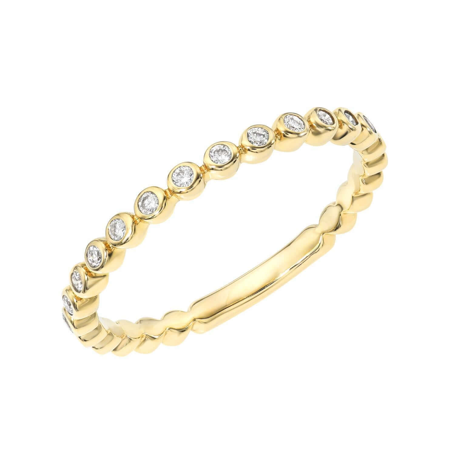The Diamond Isla Ring from Janet Heller Fine Jewelry is crafted in 14KT gold and features small round diamonds set in individual bezels around the band. The ring can be stacked or worn on its own.
