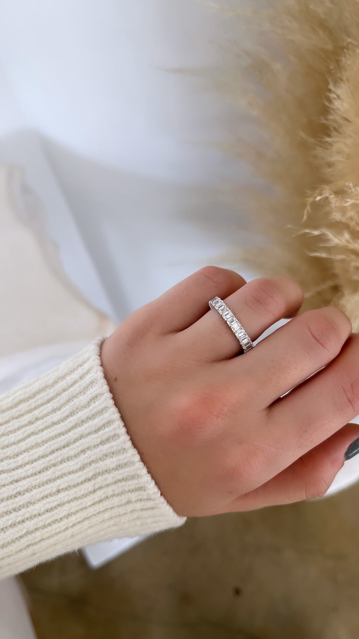 The Full Diamond Eternity Ring from Janet Heller Fine Jewelry, crafted in 18KT gold, features evenly spaced diamonds offered in various shapes and custom carat weights. The color of the diamonds is F and the clarity is VS. This is the perfect wedding band to be worn alone or stacked with your engagement ring.