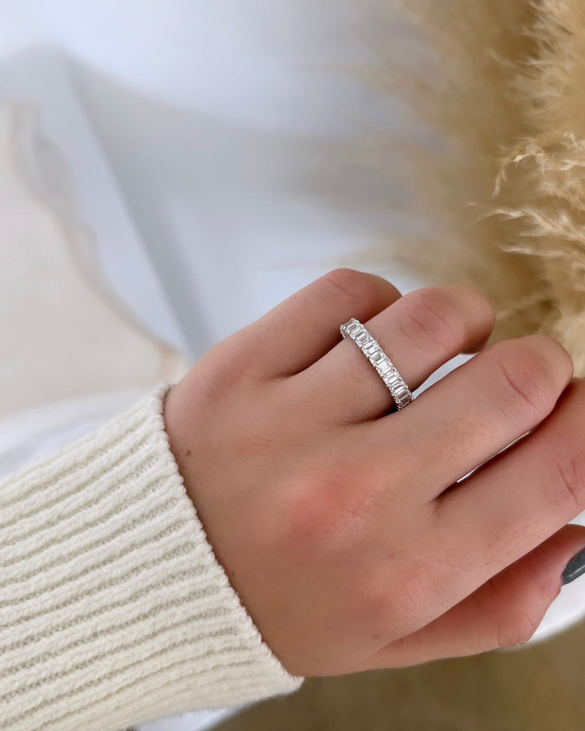 The Full Lab Grown Diamond Eternity Ring from Janet Heller Fine Jewelry, crafted in 18KT gold, features evenly spaced diamonds offered in various shapes and custom carat weights. The color of the diamonds is F and the clarity is VS. This is the perfect wedding band to be worn alone or stacked with your engagement ring.