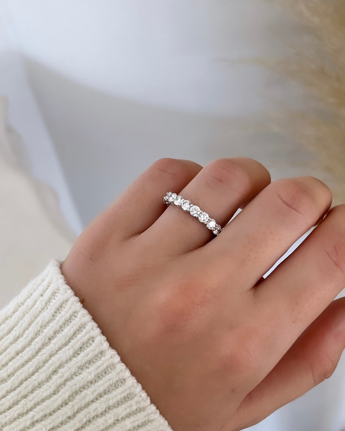 The Full Diamond Eternity Ring from Janet Heller Fine Jewelry, crafted in 18KT gold, features evenly spaced diamonds offered in various shapes and custom carat weights. The color of the diamonds is F and the clarity is VS. This is the perfect wedding band to be worn alone or stacked with your engagement ring.
