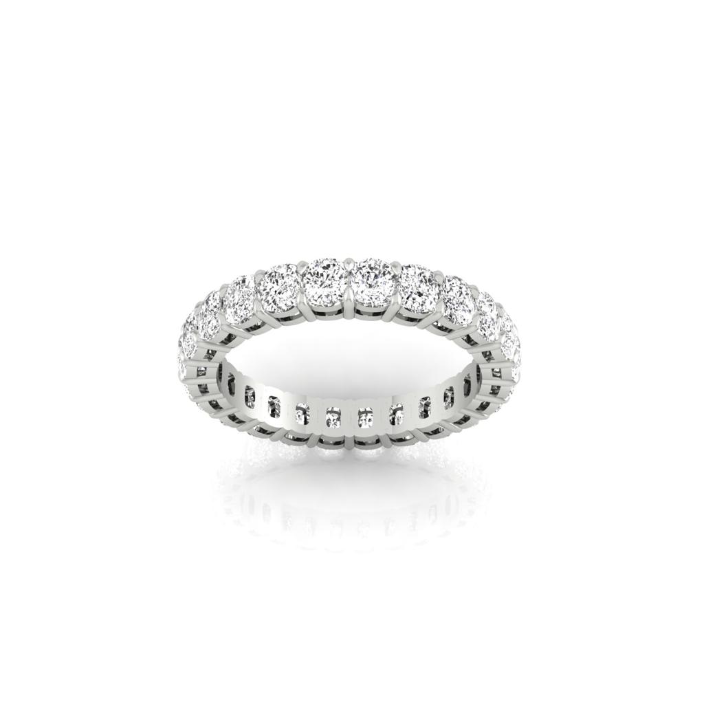 The Full Lab Grown Diamond Eternity Ring features a silver band with a circle of round-cut diamonds, F Color, VS Clarity, all set in prongs. The 18KT gold band enhances the diamonds brilliance and elegance beneath its polished surface.