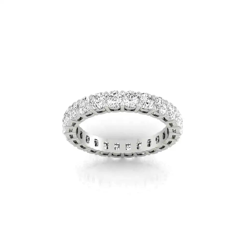 The Full Diamond Eternity Ring boasts a seamless row of brilliant-cut diamonds with F Color and VS Clarity, elegantly set in a striking white metal band against a pristine white background.