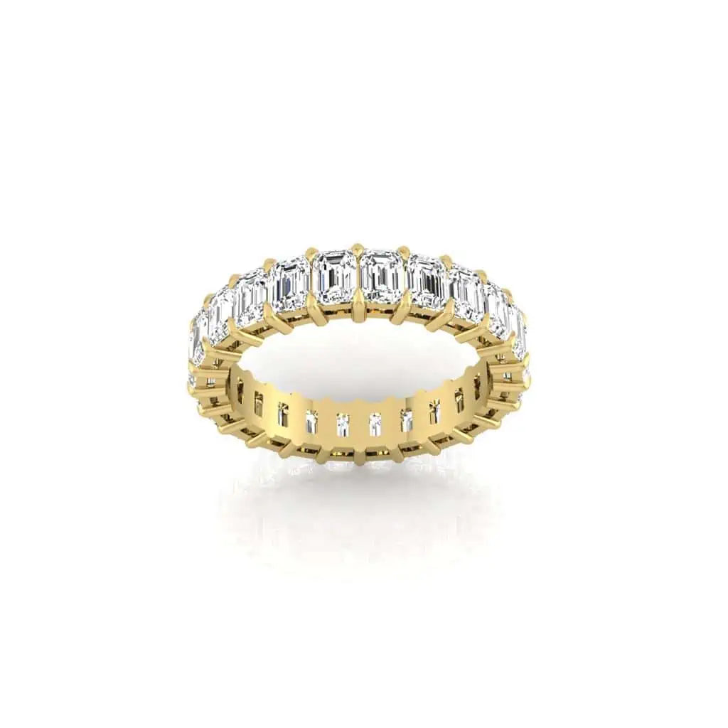 The Full Diamond Eternity Ring from Janet Heller Fine Jewelry, crafted in 18KT gold, features evenly spaced diamonds offered in various shapes and custom carat weights. The color of the diamonds is F and the clarity is VS. This is the perfect wedding band to be worn alone or stacked with your engagement ring.