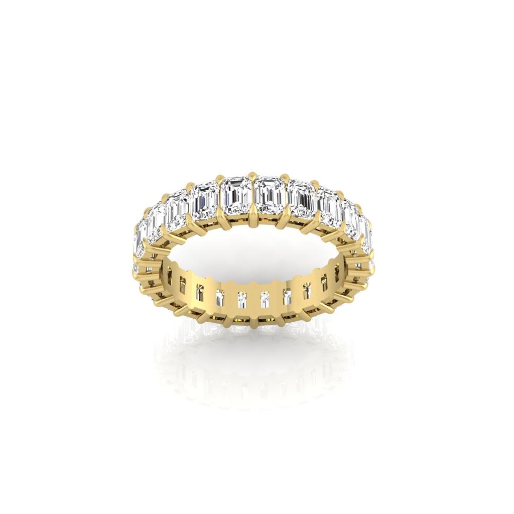 The Full Lab Grown Diamond Eternity Ring from Janet Heller Fine Jewelry, crafted in 18KT gold, features evenly spaced diamonds offered in various shapes and custom carat weights. The color of the diamonds is F and the clarity is VS. This is the perfect wedding band to be worn alone or stacked with your engagement ring.
