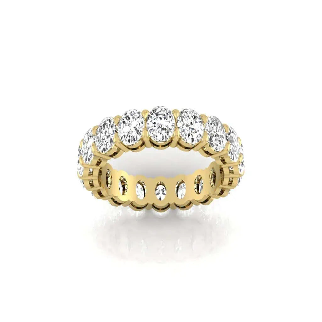 The Full Diamond Eternity Ring from Janet Heller Fine Jewelry, crafted in 18KT gold, features evenly spaced diamonds offered in various shapes and custom carat weights. The color of the diamonds is F and the clarity is VS. This is the perfect wedding band to be worn alone or stacked with your engagement ring.