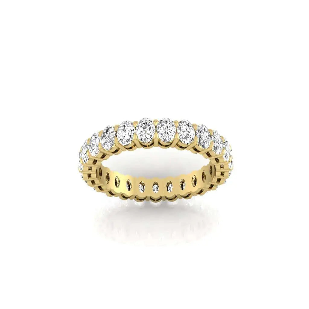 The Full Diamond Eternity Ring from Janet Heller Fine Jewelry, crafted in 18KT gold, features evenly spaced diamonds offered in various shapes and custom carat weights. The color of the diamonds is F and the clarity is VS. This is the perfect wedding band to be worn alone or stacked with your engagement ring.