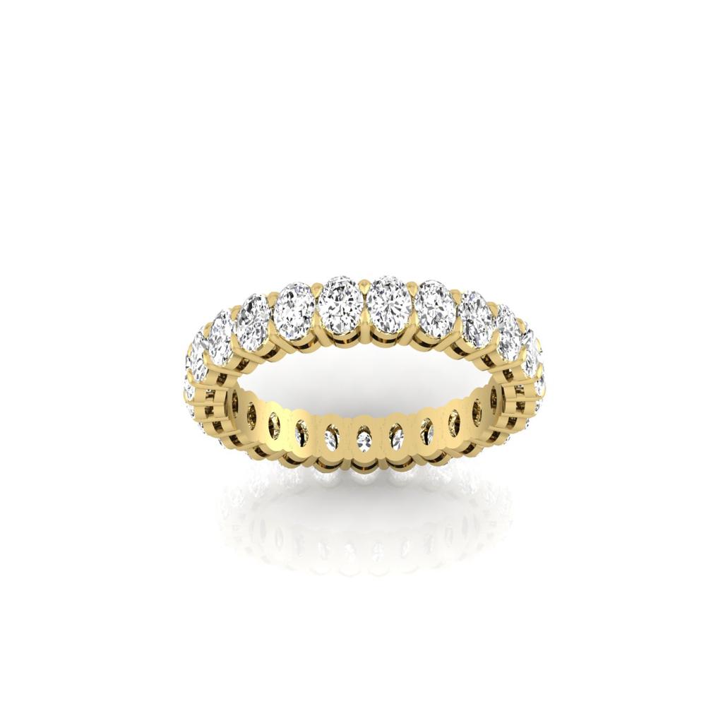 The Full Lab Grown Diamond Eternity Ring from Janet Heller Fine Jewelry, crafted in 18KT gold, features evenly spaced diamonds offered in various shapes and custom carat weights. The color of the diamonds is F and the clarity is VS. This is the perfect wedding band to be worn alone or stacked with your engagement ring.