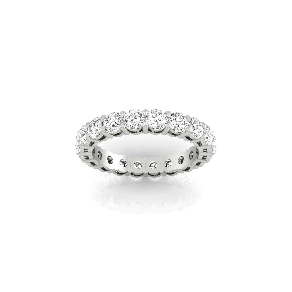 A Full Lab Grown Diamond Eternity Ring featuring F Color VS Clarity sparkling round diamonds set in silver. The ring is elegantly displayed on a white background with a shiny, reflective surface beneath it.