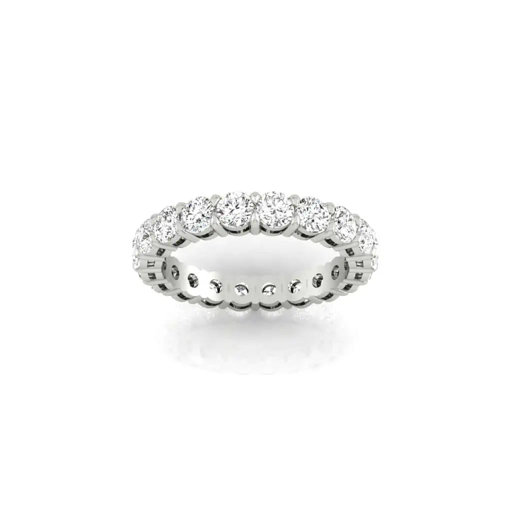 The Full Diamond Eternity Ring from Janet Heller Fine Jewelry, crafted in 18KT gold, features evenly spaced diamonds offered in various shapes and custom carat weights. The color of the diamonds is F and the clarity is VS. This is the perfect wedding band to be worn alone or stacked with your engagement ring.