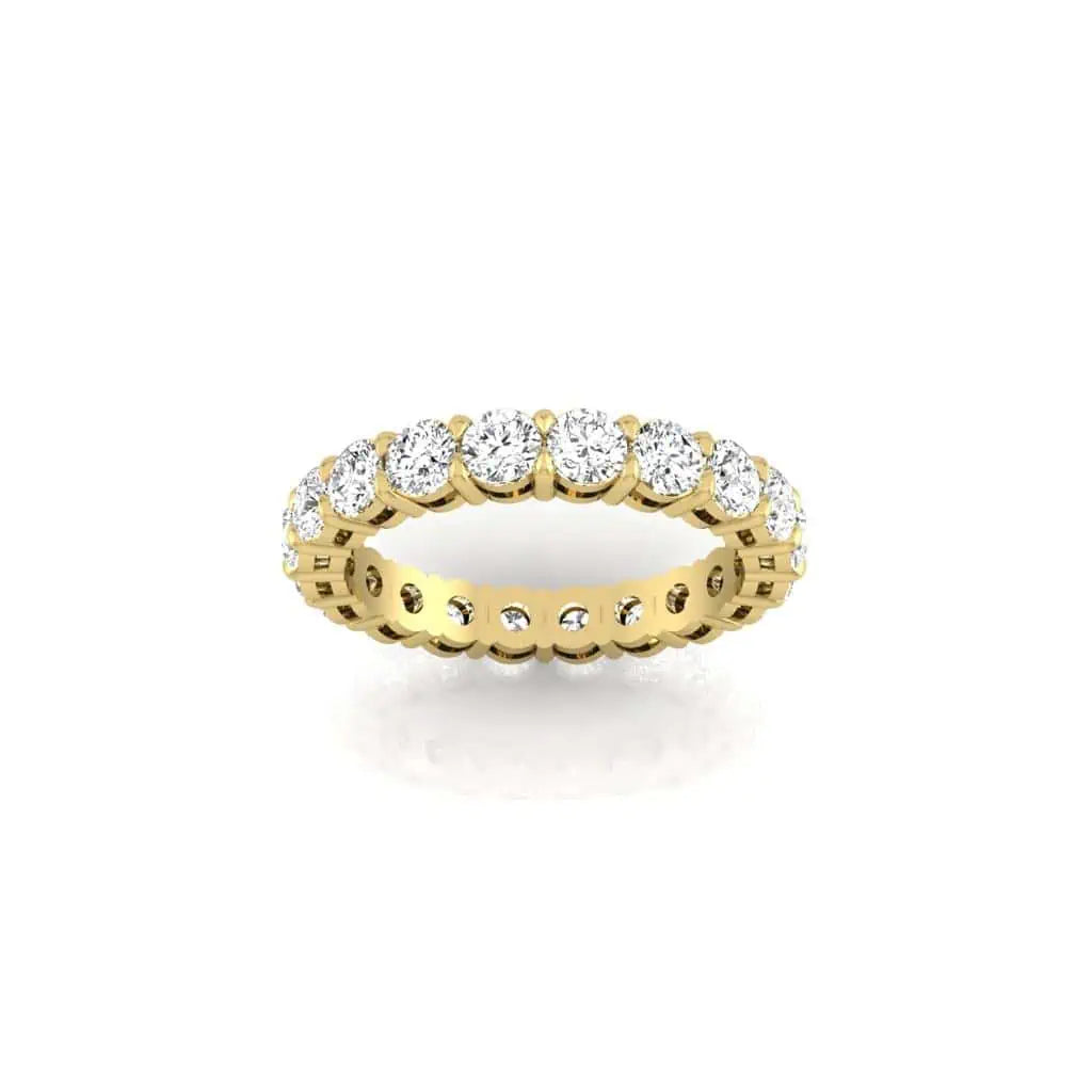 The Full Diamond Eternity Ring from Janet Heller Fine Jewelry, crafted in 18KT gold, features evenly spaced diamonds offered in various shapes and custom carat weights. The color of the diamonds is F and the clarity is VS. This is the perfect wedding band to be worn alone or stacked with your engagement ring.