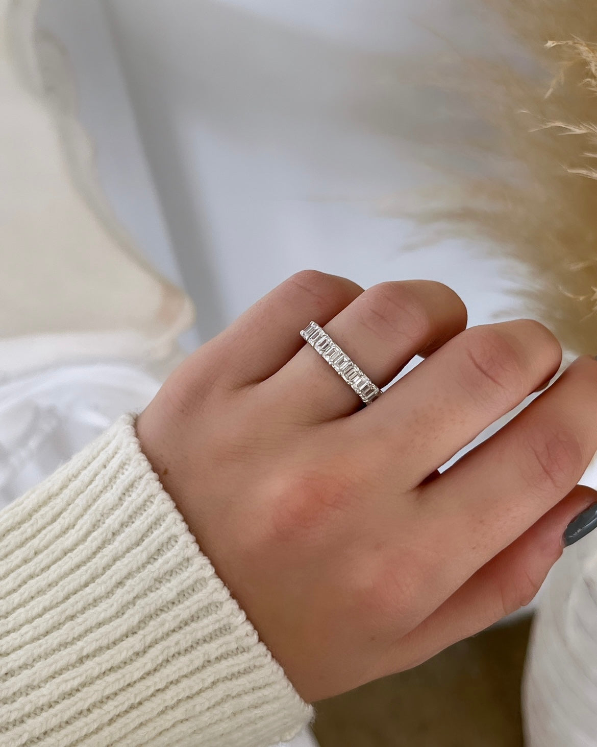 The Full Lab Grown Diamond Eternity Ring from Janet Heller Fine Jewelry, crafted in 18KT gold, features evenly spaced diamonds offered in various shapes and custom carat weights. The color of the diamonds is F and the clarity is VS. This is the perfect wedding band to be worn alone or stacked with your engagement ring.