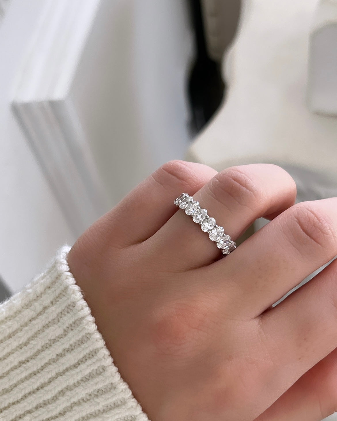 The Full Lab Grown Diamond Eternity Ring from Janet Heller Fine Jewelry, crafted in 18KT gold, features evenly spaced diamonds offered in various shapes and custom carat weights. The color of the diamonds is F and the clarity is VS. This is the perfect wedding band to be worn alone or stacked with your engagement ring.