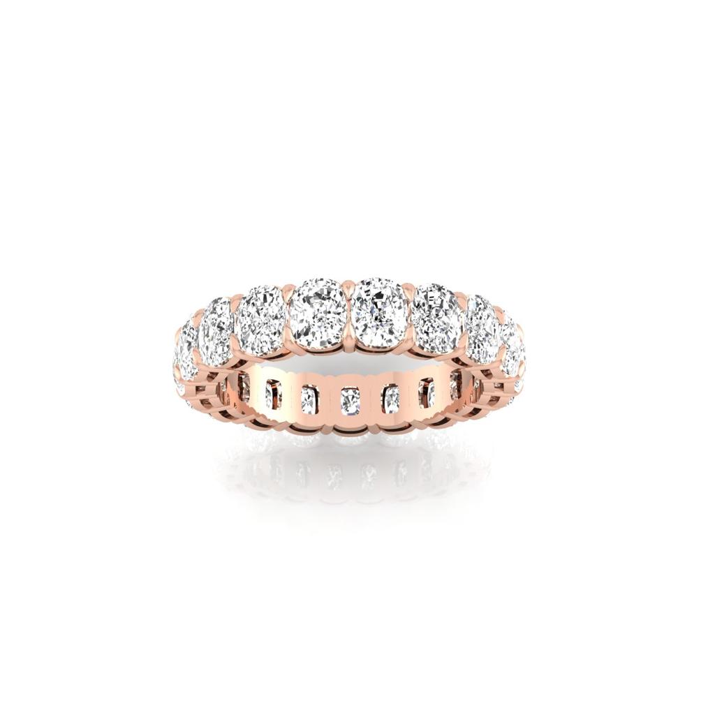The Full Lab Grown Diamond Eternity Ring from Janet Heller Fine Jewelry, crafted in 18KT gold, features evenly spaced diamonds offered in various shapes and custom carat weights. The color of the diamonds is F and the clarity is VS. This is the perfect wedding band to be worn alone or stacked with your engagement ring.