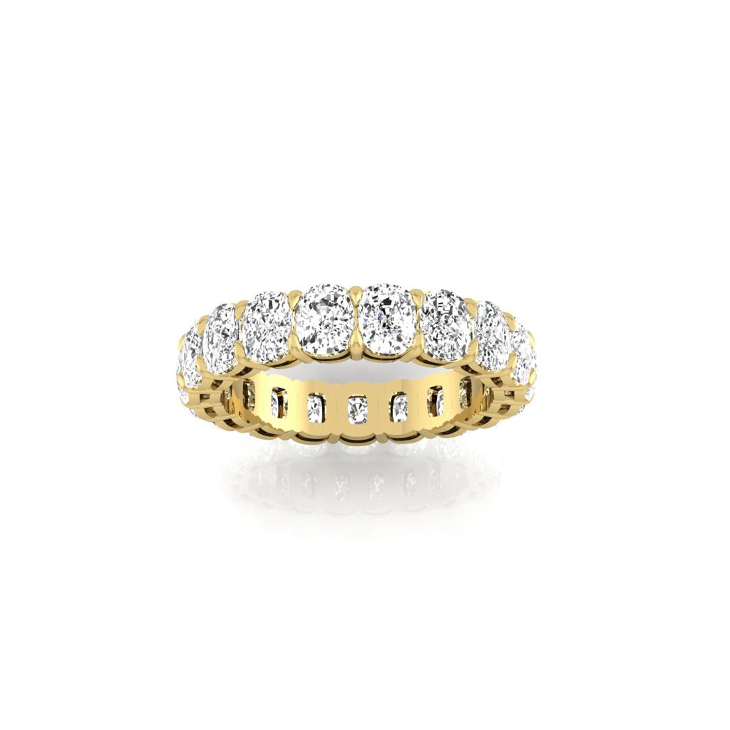 The Full Lab Grown Diamond Eternity Ring from Janet Heller Fine Jewelry, crafted in 18KT gold, features evenly spaced diamonds offered in various shapes and custom carat weights. The color of the diamonds is F and the clarity is VS. This is the perfect wedding band to be worn alone or stacked with your engagement ring.