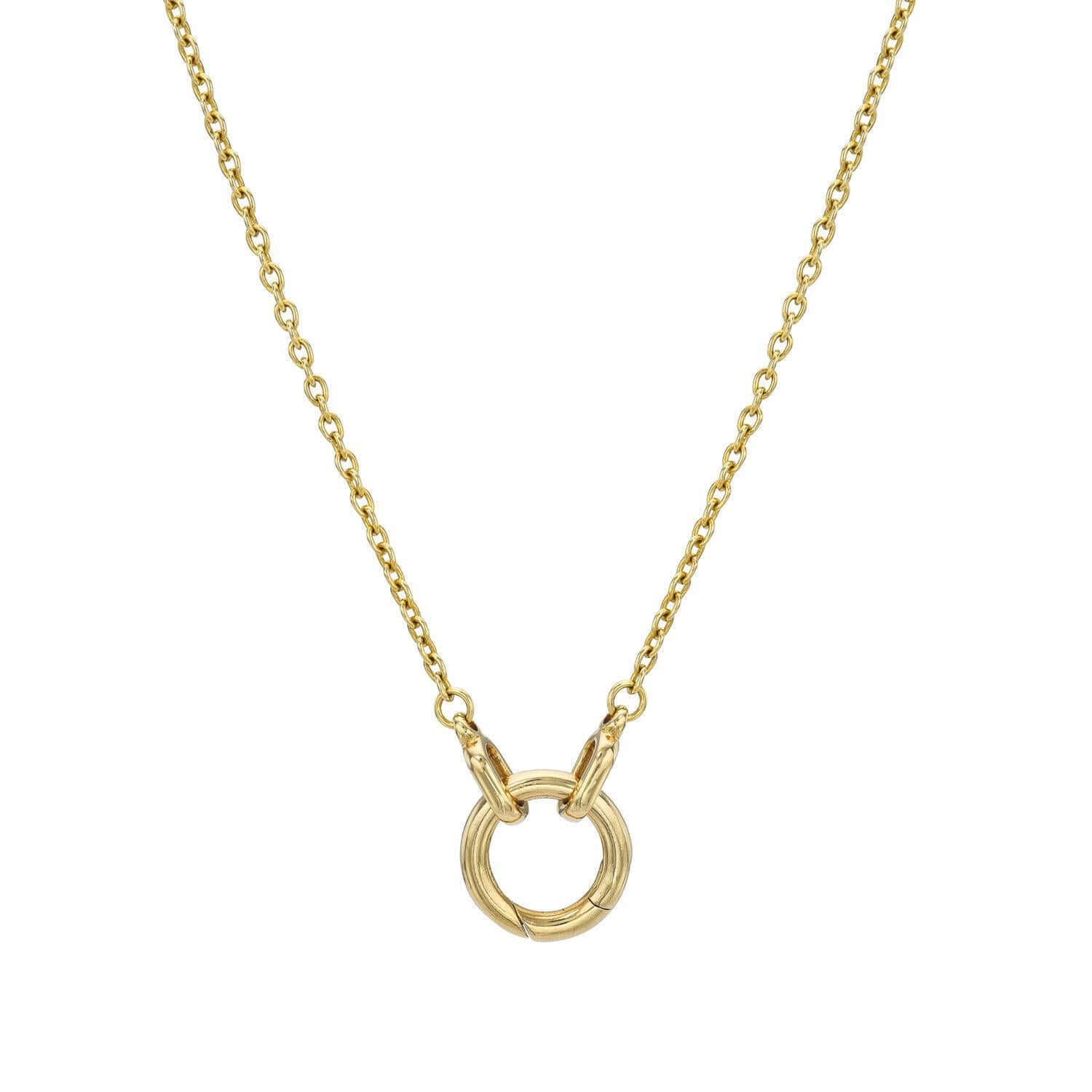 The Donut Cable Chain Necklace from Janet Heller Fine Jewelry is crafted in 14KT gold and features a delicate chain and a circular pendant with two interlocking rings. It is the perfect necklace to showcase a variety of Janet Heller Fine Jewelry charms.