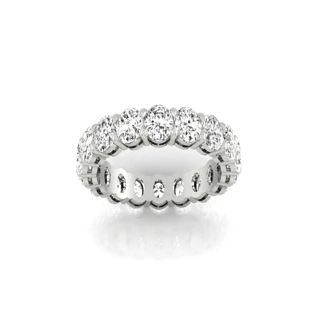 The Full Diamond Eternity Ring from Janet Heller Fine Jewelry, crafted in 18KT gold, features evenly spaced diamonds offered in various shapes and custom carat weights. The color of the diamonds is F and the clarity is VS. This is the perfect wedding band to be worn alone or stacked with your engagement ring.
