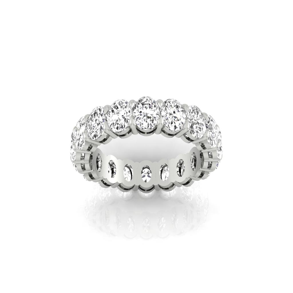 The Full Lab Grown Diamond Eternity Ring from Janet Heller Fine Jewelry, crafted in 18KT gold, features evenly spaced diamonds offered in various shapes and custom carat weights. The color of the diamonds is F and the clarity is VS. This is the perfect wedding band to be worn alone or stacked with your engagement ring.