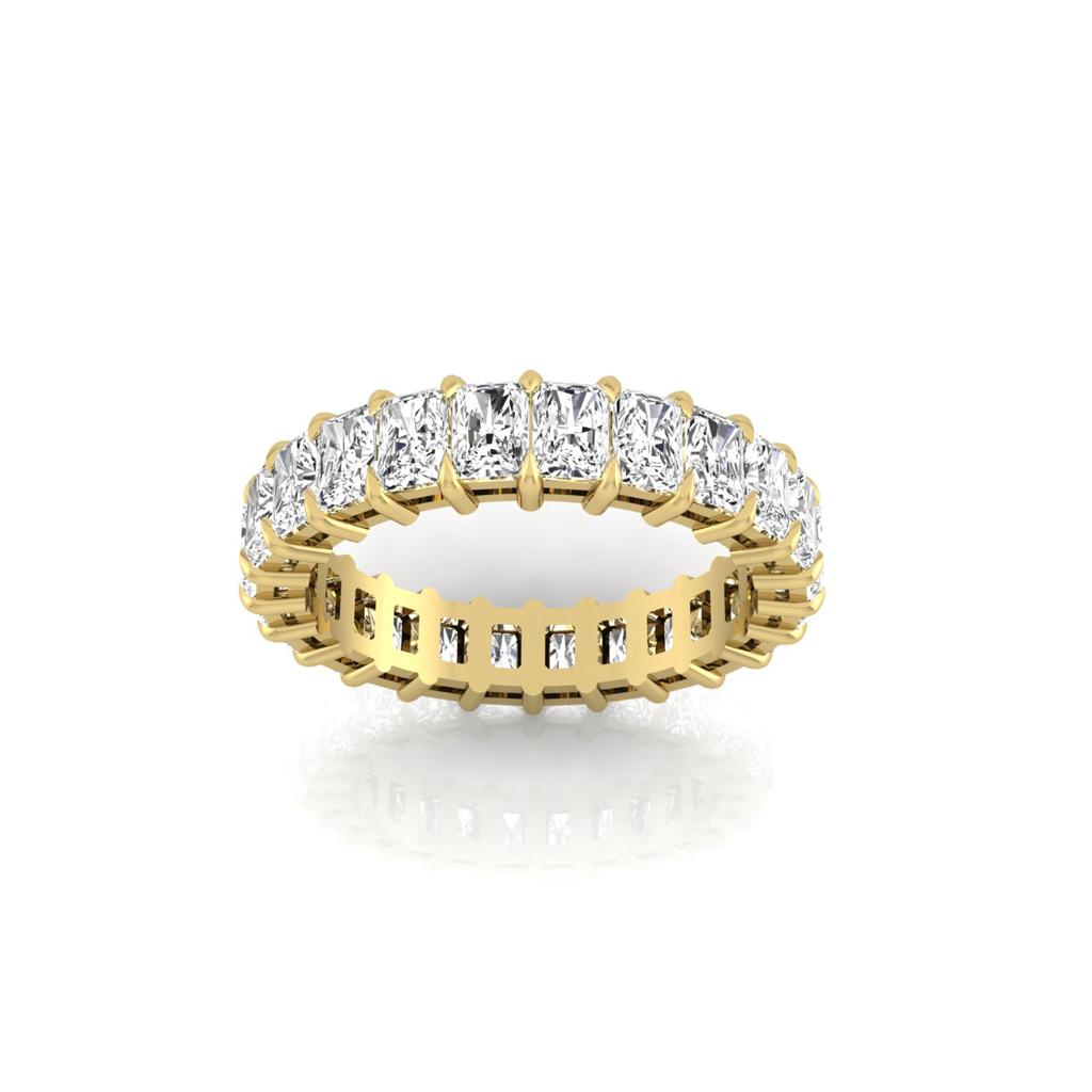 The Full Lab Grown Diamond Eternity Ring showcases a continuous row of rectangular-cut diamonds with F Color VS Clarity. These are set in an elegant 18KT gold band, offering a secure and luxurious sparkle against the smooth surface.