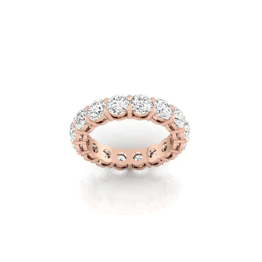 The Full Diamond Eternity Ring from Janet Heller Fine Jewelry, crafted in 18KT gold, features evenly spaced diamonds offered in various shapes and custom carat weights. The color of the diamonds is F and the clarity is VS. This is the perfect wedding band to be worn alone or stacked with your engagement ring.