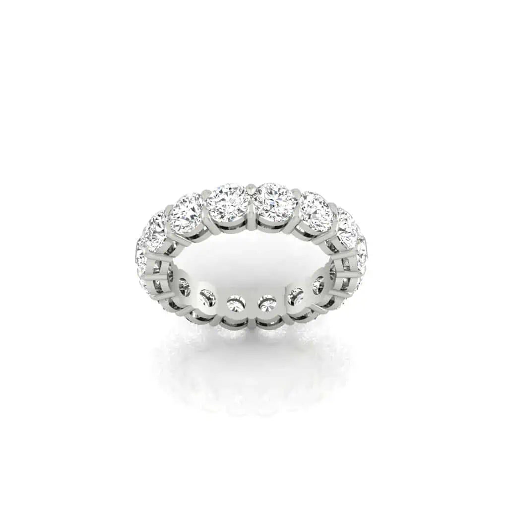 The Full Diamond Eternity Ring from Janet Heller Fine Jewelry, crafted in 18KT gold, features evenly spaced diamonds offered in various shapes and custom carat weights. The color of the diamonds is F and the clarity is VS. This is the perfect wedding band to be worn alone or stacked with your engagement ring.