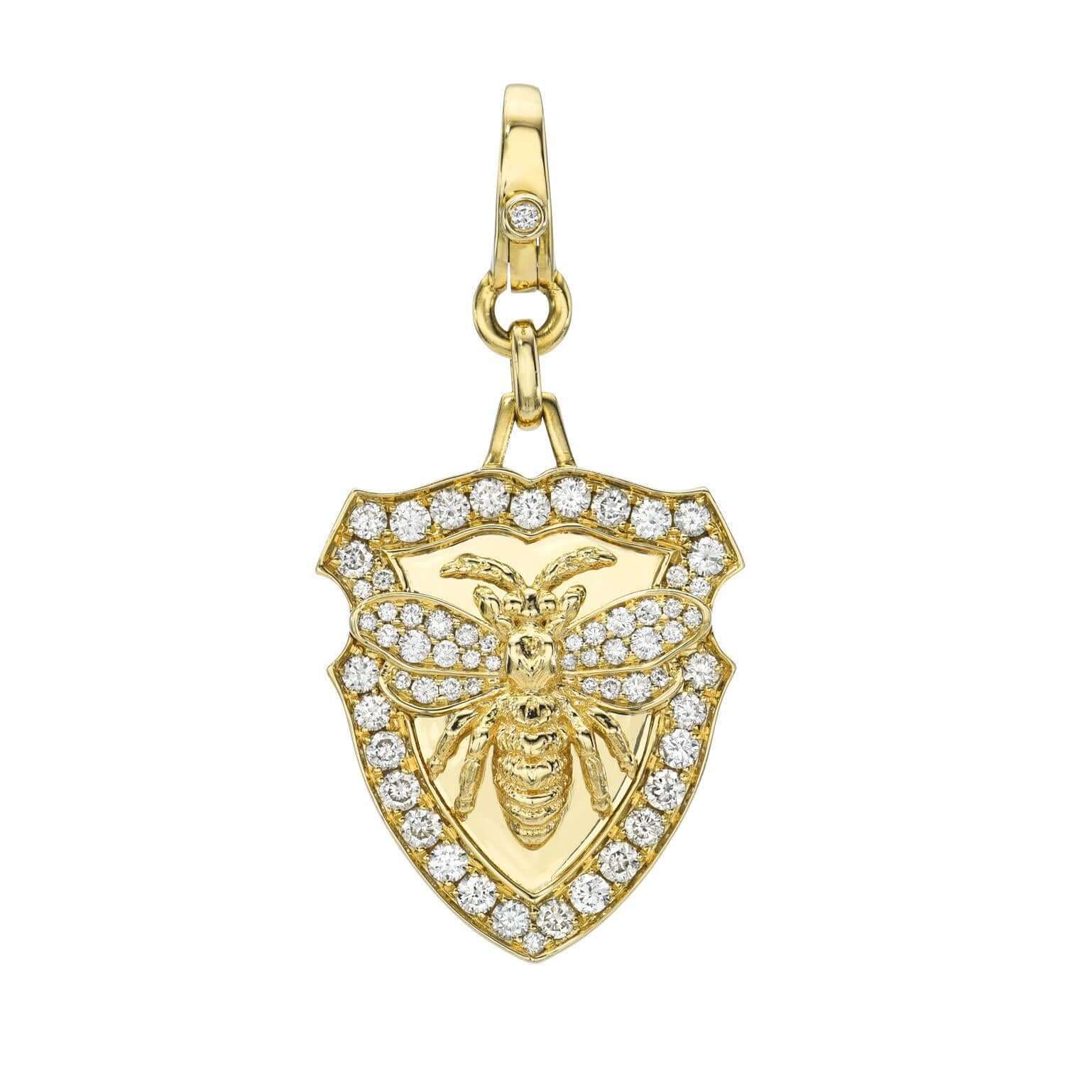 The Diamond Queen Bee Charm from Janet Heller Fine Jewelry is a gold shield pendant featuring a detailed bee and surrounded by sparkling diamonds. Customize it with unique jewelry charms to make it truly yours.