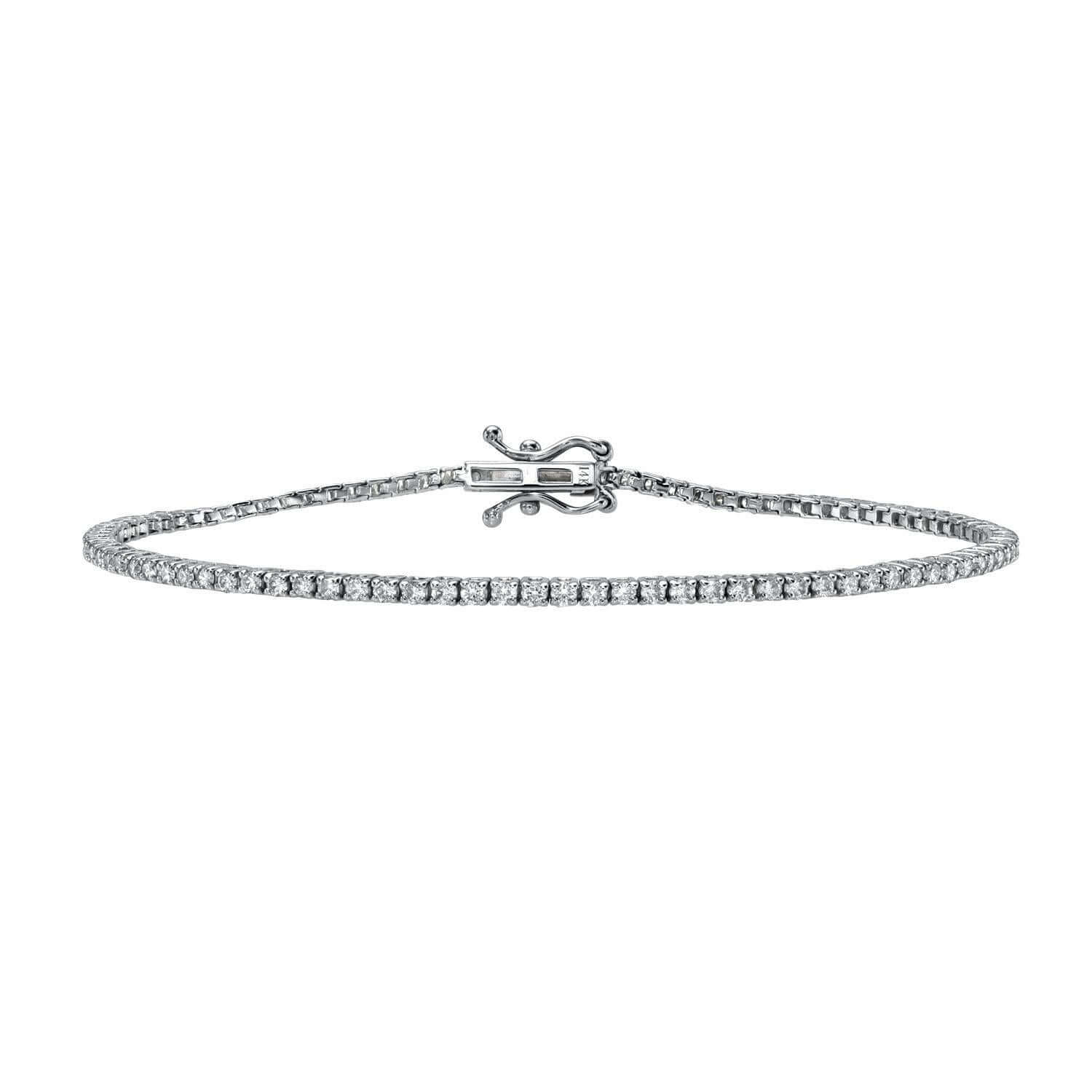 The 1ct Round Diamond Tennis Bracelet from Janet Heller Fine Jewelry is adorned with small, round-cut natural diamonds. The bracelet can be worn on its own or stacked with other bracelets.