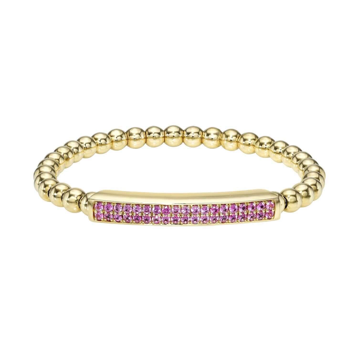 The Pink Sapphire Lennon Stretchy Bracelet from Janet Heller Fine Jewelry is crafted in 14KT gold. The bracelet features a beaded design with a rectangular bar set with pink sapphires. It can be worn alone or stacked with other bracelets.