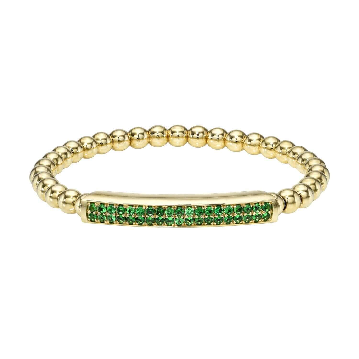 The Tsavorite Lennon Stretchy Bracelet from Janet Heller Fine Jewelry is crafted in 14KT gold. The tsavorite bracelet features a rectangular central section with a beaded band. The bracelet can be worn alone or stacked with other bracelets.