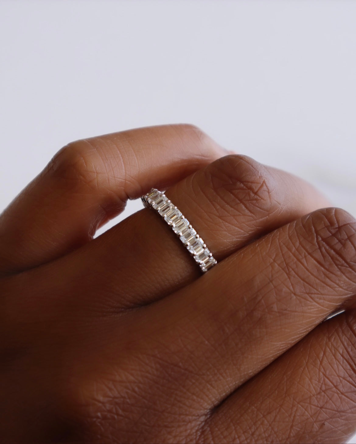 The Full Diamond Eternity Ring from Janet Heller Fine Jewelry, crafted in 18KT gold, features evenly spaced diamonds offered in various shapes and custom carat weights. The color of the diamonds is F and the clarity is VS. This is the perfect wedding band to be worn alone or stacked with your engagement ring.