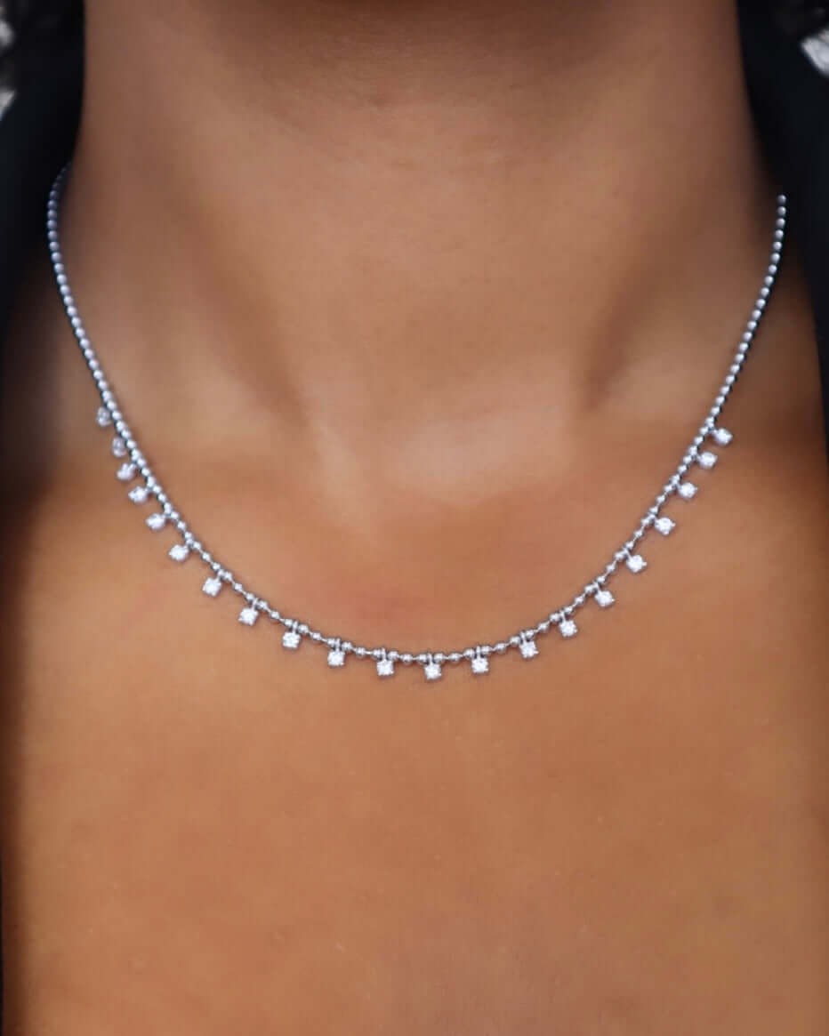 The Diamond Kylie Necklace from Janet Heller Fine Jewelry crafted in 14KT white gold is adorned with dangling diamond pendants. The necklace can be worn on its own or layered with other chains.